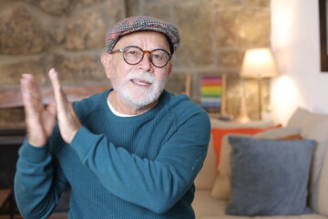 Senior man applauding with satisfaction