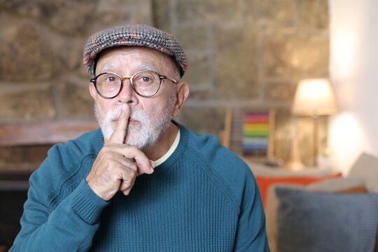 Senior man asking for silence with gesture