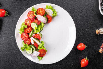 salad vegetables cucumber, tomato, onion, lettuce food organic products meal snack copy space food background rustic. top view keto or paleo diet veggie vegan or vegetarian food