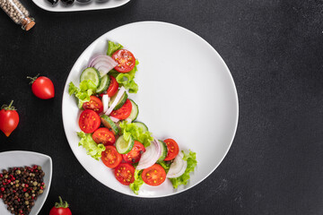 salad vegetables cucumber, tomato, onion, lettuce food organic products meal snack copy space food background rustic. top view keto or paleo diet veggie vegan or vegetarian food