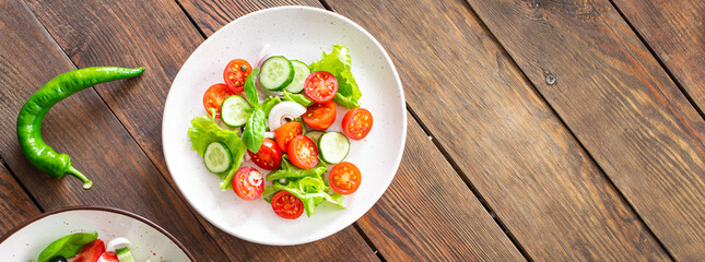 salad vegetables cucumber, tomato, onion, lettuce food organic products meal snack copy space food background rustic. top view keto or paleo diet veggie vegan or vegetarian food