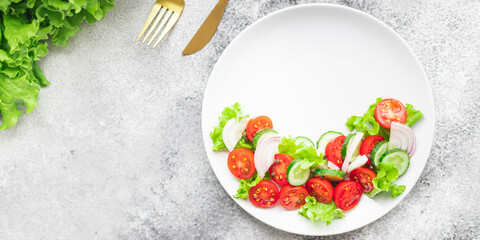 salad vegetables cucumber, tomato, onion, lettuce food organic products meal snack copy space food background rustic. top view keto or paleo diet veggie vegan or vegetarian food