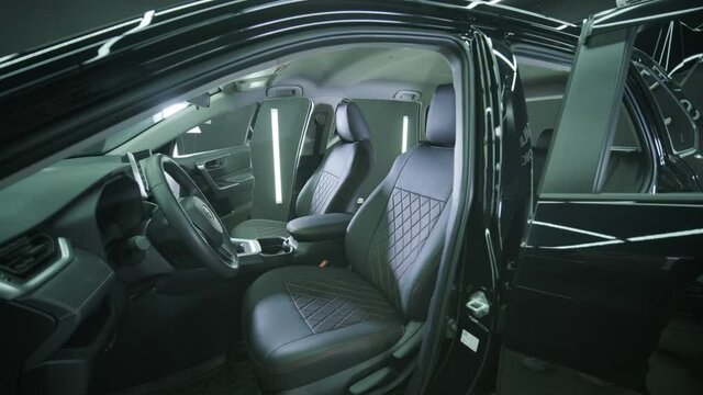 Black leather seat covers in the car. Beautiful leather car interior design. Luxury leather seats in the car.