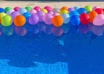 Balloons of colors floating in a pool