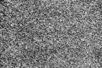 white granules of rubber and polypropylene on a black background. Plastics and polymers industry.