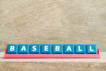Tile alphabet letter with word baseball in red color rack on wood background