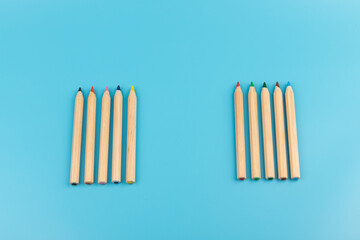 Wooden colorful ordinary pencils isolated on blue background