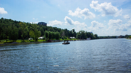 A large multi-storey building on the outskirts of the city. View from the Moscow River