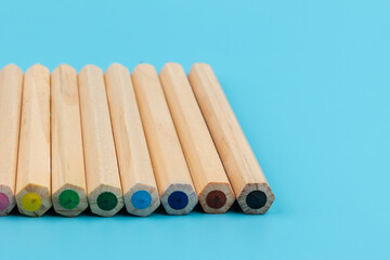 Wooden colorful ordinary pencils isolated on blue background