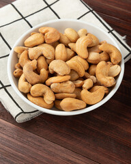 Cashew nuts in white bowl on the table, Healthy snack, Vegetarian food.