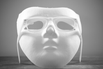 white mask with white eyeglass frames on a white background