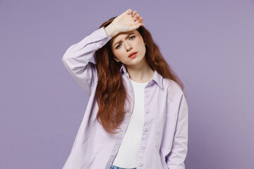 Young redhead woman 20s wears white T-shirt violet jacket put hand on head rub temples has headache suffer from migraine feel bad seedy isolated on pastel purple color wall background studio portrait