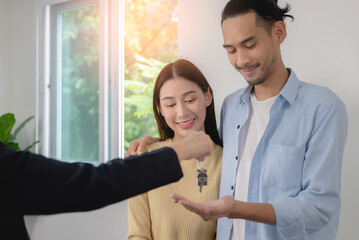 landlord property agency giving a room key to new tenant