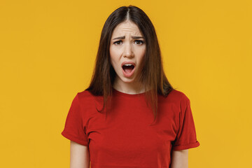 Angry shocked disgusted frowning amazed abhorred young brunette woman 20s wears basic red t-shirt...