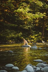 Boy in the river at the golden hour