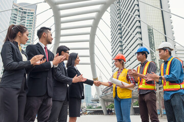 Multiethnic group of business people with engineer partner handshake with contract agreement of business project