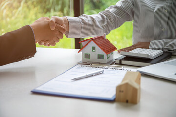 Real estate broker or Businessmen and customer shaking hands after signing a contract, real estate, home loan and insurance concept,
