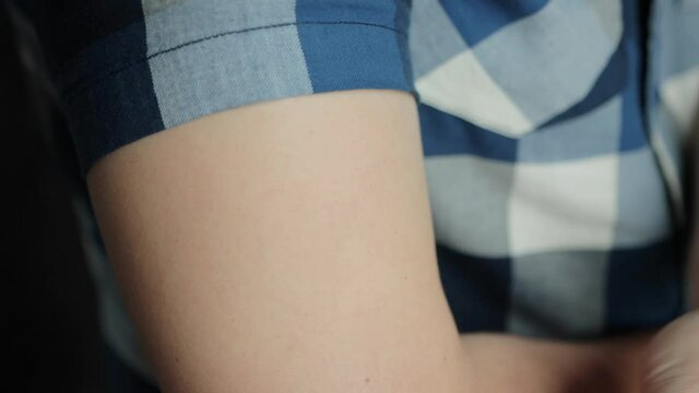 A man removes a used anti-smoking plaster from his hand, close-up. Quitting smoking