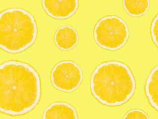 Slices of lemons on a yellow background. Seamless pattern.