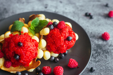Delicious hong kong waffles. Waffles with strawberry ice cream and berries. Waffles on the table 