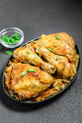 Spicy roasted chicken with vegetables  on dark background. Space for text.