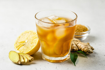 Summer mocktail, iced lemon ginger tea in glasses. Space for text.