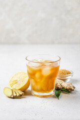Fresh lemon honey iced ginger tea in glasses. Space for text.
