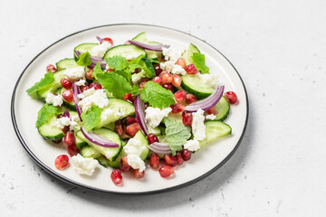 Summer fresh pomegranate cucumber salad, red onion mint vinegar gressing. Space for text.