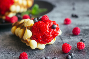 Delicious hong kong waffles. Waffles with strawberry ice cream and berries. Waffles on the table 
