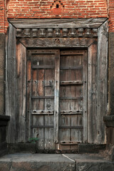 Fototapeta na wymiar old vintage wooden door on retro wall, Wafgaon, India.