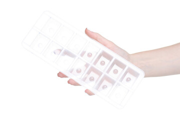 plastic ice cube tray in hand on white background isolation