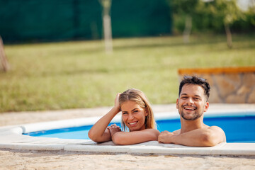 Adult people, relaxing at the swimming pool.