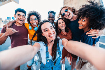 Multicultural happy friends having fun taking group selfie portrait on city street - Multiracial...