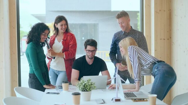 Video of group of successful smart business team celebrating good job while holding up their right hands on coworking place.