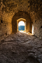 Obraz premium door at the end of the stone tunnel