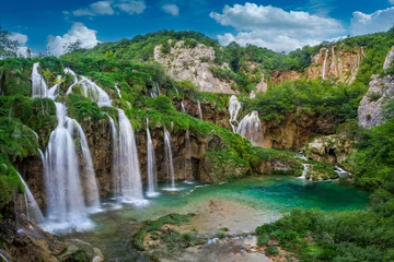  Plitvice, Croatia - Beautiful waterfalls of Plitvice Lakes (Plitvička jezera) in Plitvice National Park on a bright summer day with blue sky and clouds and green foliage and turquise water © zgphotography