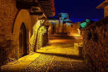 Old town main square at night with arched doors. Santillana del Mar, Santander.