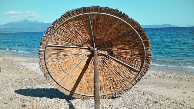 Beach umbrella lying on the Aegean sea coast in Asprovalta, Greece