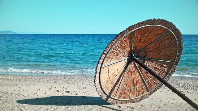 Beach umbrella lying on the Aegean sea coast in Asprovalta, Greece
