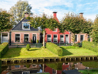 Houses with waterside gardens on Eegracht canal in IJlst, Friesland, Netherlands