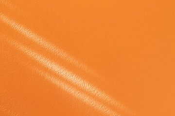 real natural rays of sunlight on orange wall