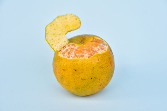 Orange mandarin fruit little open on the top isolated on color background