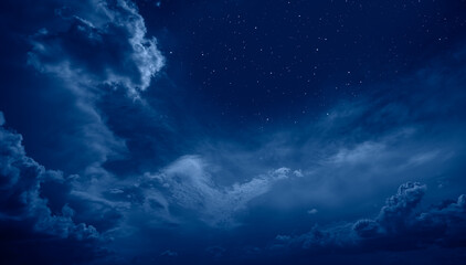 Naklejka na ściany i meble Night sky in the clouds with many stars