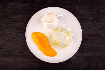 glutinous rice with mango made for steam is served with coconut milk sauce
