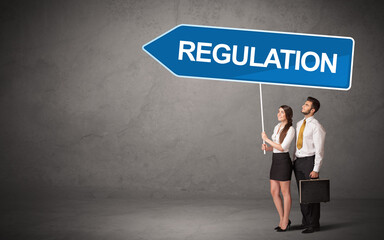 Young business person in casual holding road sign
