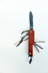 Pocket knife, with bottle opener, scissor,screwdriver,wine opener isolated on color background