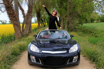woman with a sports car convertible rural scene