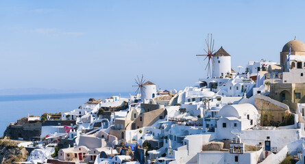 Oia village, Santorini, Greece. View of traditional houses in Santorini. Small narrow streets and rooftops of houses, churches and hotels. Landscape at the day time. Travel and vacation photography.