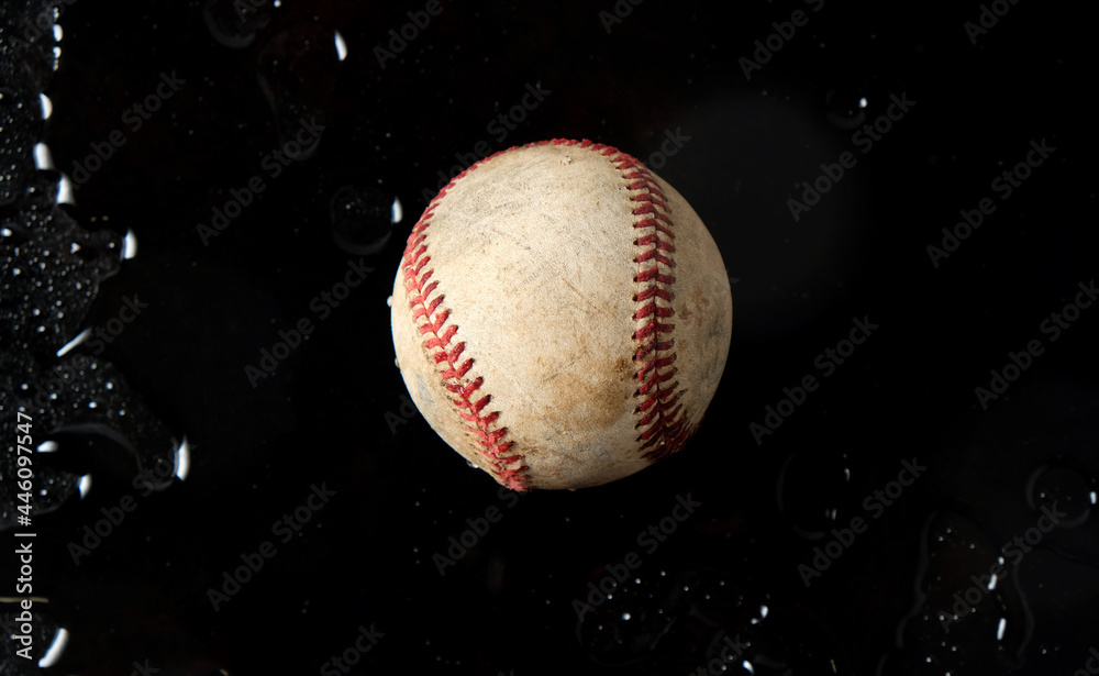 Wall mural Old sports banner with used baseball ball in dark black water background. - Wall murals
