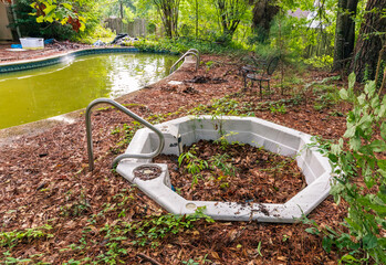 Filthy backyard pool and hot tub in ruins